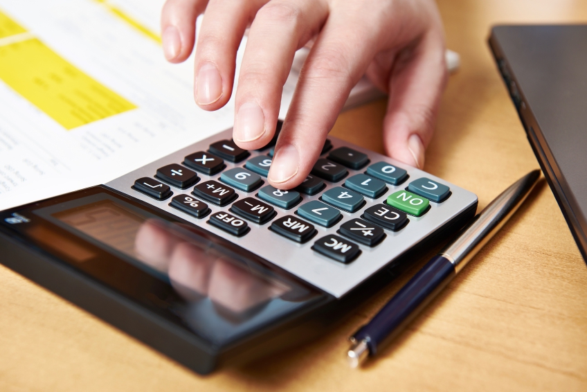 A woman's hand using a calculator