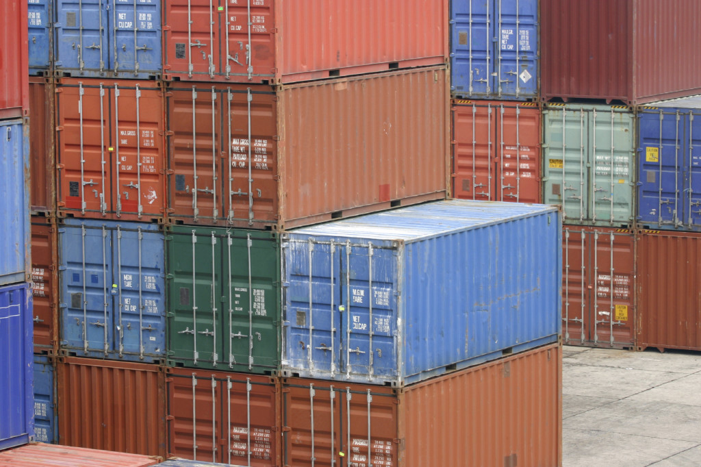 stacks of shipping containers at a port